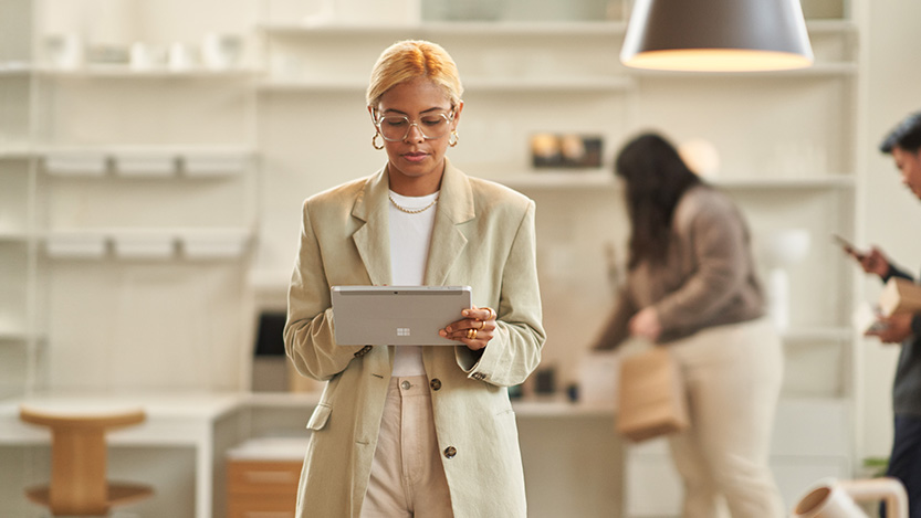 A young businesswoman working on her Surface Pro 9